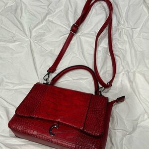 Red Crossbody Bag with Adjustable Strap and Structured Design